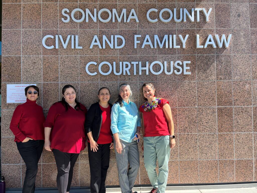 Sonoma and Napa county courthouse employees (from left) Maria Galvez, Monica Aparicio, Elva Murillo-Nunez, and Christina Guerrero Harmon pose in front of the Sonoma County Civil and Family Law Courthouse on March 11, 2022. (Courtesy Christina Guerrero Harmon)