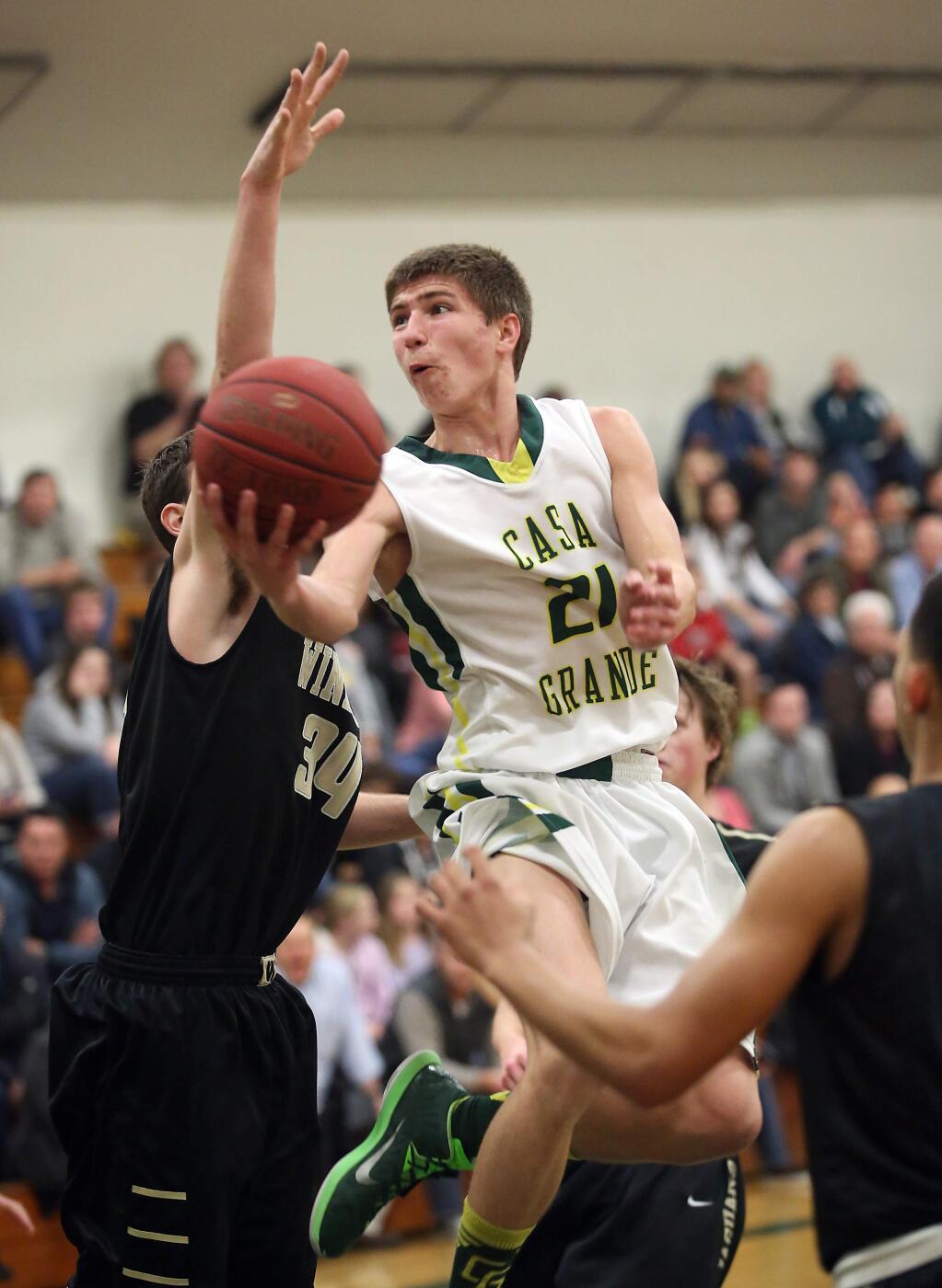 Casa Grande's Robbie Sheldon goes up for two as Windsor's Brent Tucker defends during the game held at Casa Grande High School, Friday, January 16, 2015. (Crista Jeremiason / The Press Democrat)