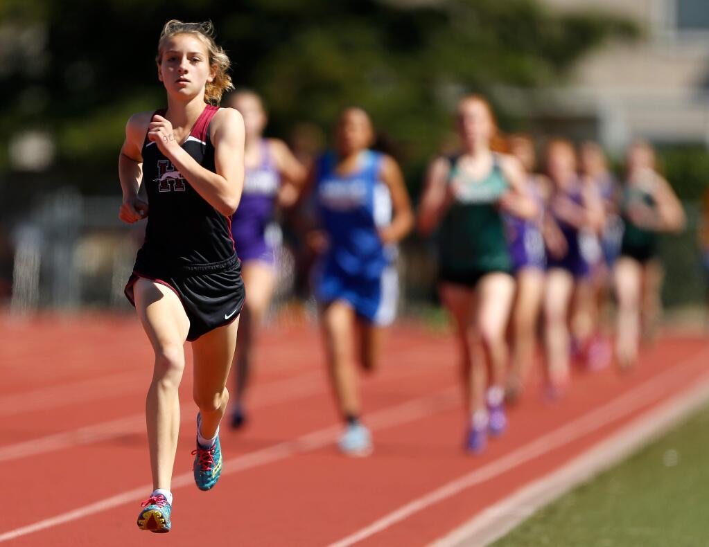 Healdsburg's Gabrielle Peterson takes a commanding lead in the varsity girls 1600-meter race and would finish first in the event, during the Sonoma County League track finals at Piner High School, in Santa Rosa, California on Saturday, May 13, 2017. (Alvin Jornada / The Press Democrat)