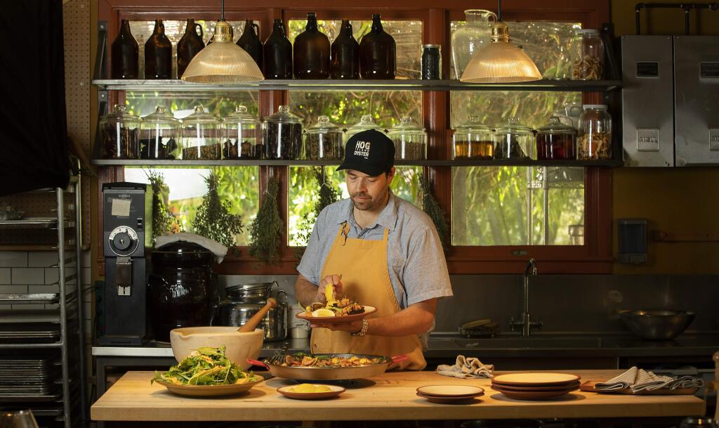 Chef Perry Hoffman serves up paella and a green salad in the kitchen at the Boonville Hotel in the Anderson Valley. (John Burgess/The Press Democrat)