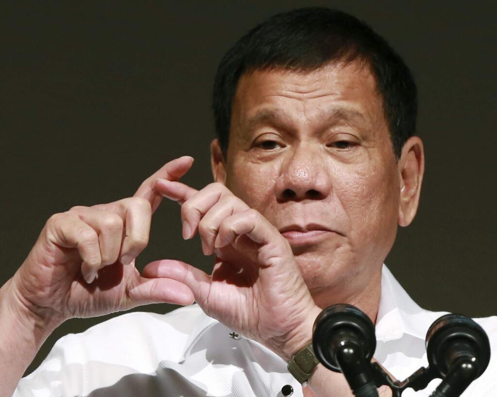 FILE - In this Oct. 26, 2016, file photo, Philippine President Rodrigo Duterte delivers a speech at the Philippine Economic Forum in Tokyo. Duterte telephoned U.S. President-elect Donald Trump late Friday, Dec. 2 and had a brief but 'very engaging, animated conversation' in which both leaders invited each other to visit his country. In a video released by Duterte's close aide, Bong Go, the Philippine leader is seen smiling while talking to Trump late Friday and saying: 'We will maintain ... and enhance the bilateral ties between our two countries.' (AP Photo/Eugene Hoshiko, File)