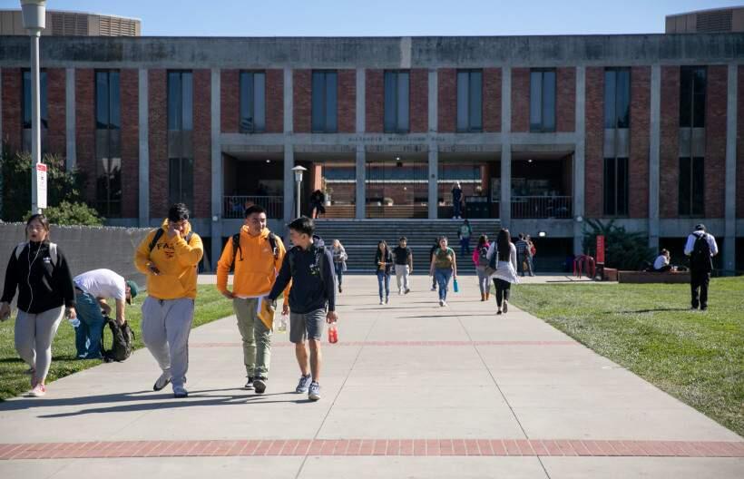Students walk near Meiklejohn Hall at California State University East Bay. Photo by Anne Wernikoff for CalMatters