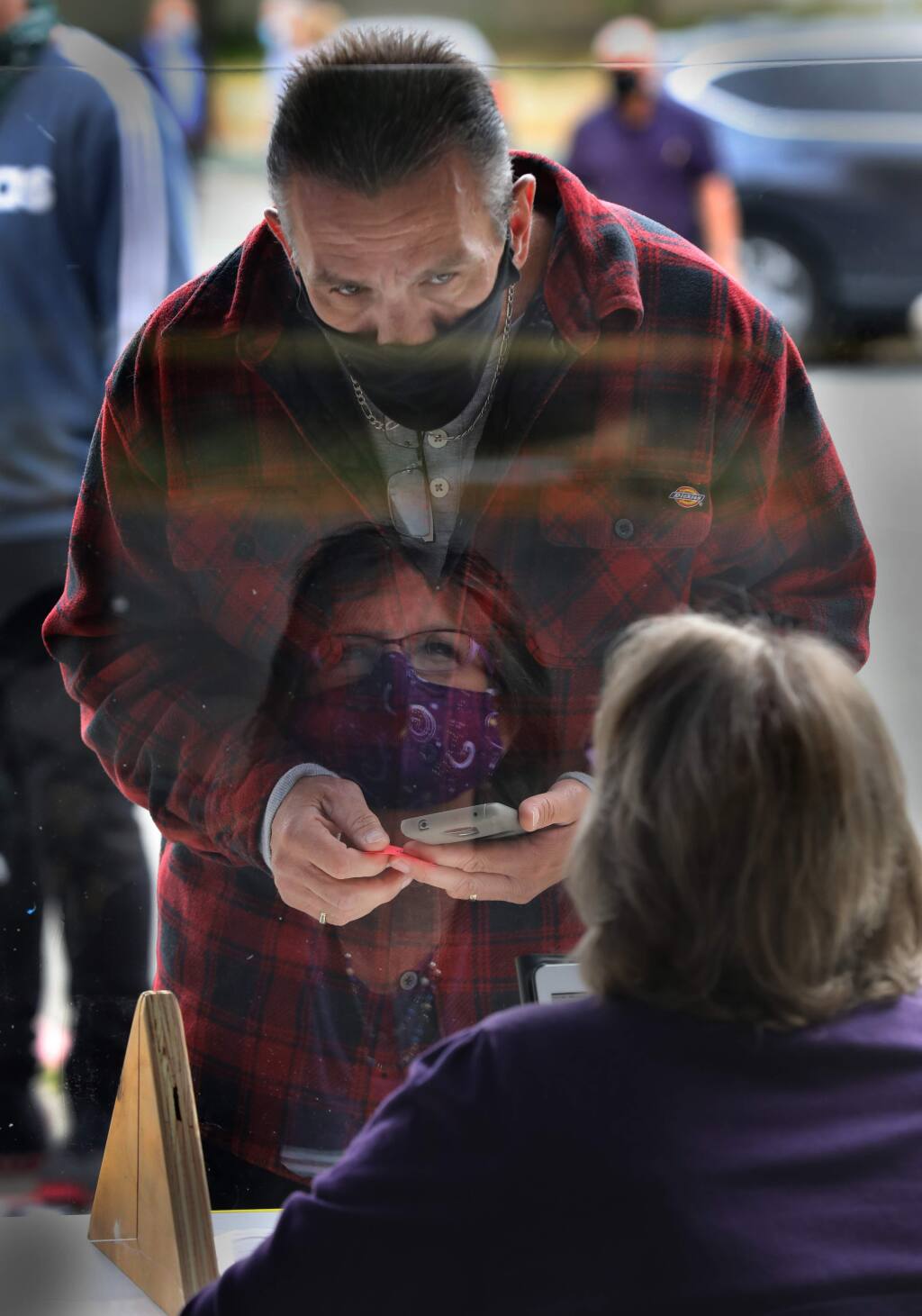 Robert Borders goes through the screening process for COVID-19 with Sonoma County Court worker Dawn P. outside the Sonoma County Superior Court in Santa Rosa, Calif., on Monday, June 1, 2020. (BETH SCHLANKER/ The Press Democrat)
