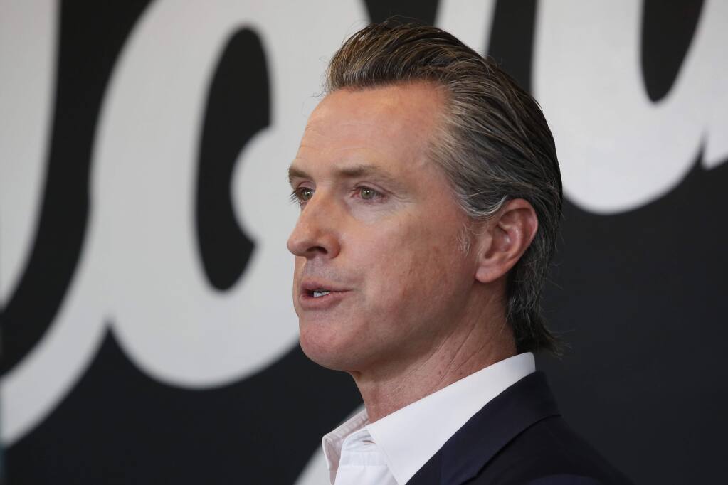 Gov. Gavin Newsom discusses his plan for the gradual reopening of California businesses during a news conference at the Display California store in Sacramento, Calif., Tuesday, May 5, 2020. Gavin Newsom has publicly scolded a pair of rural counties for allowing some businesses to reopen. (AP Photo/Rich Pedroncelli, Pool)