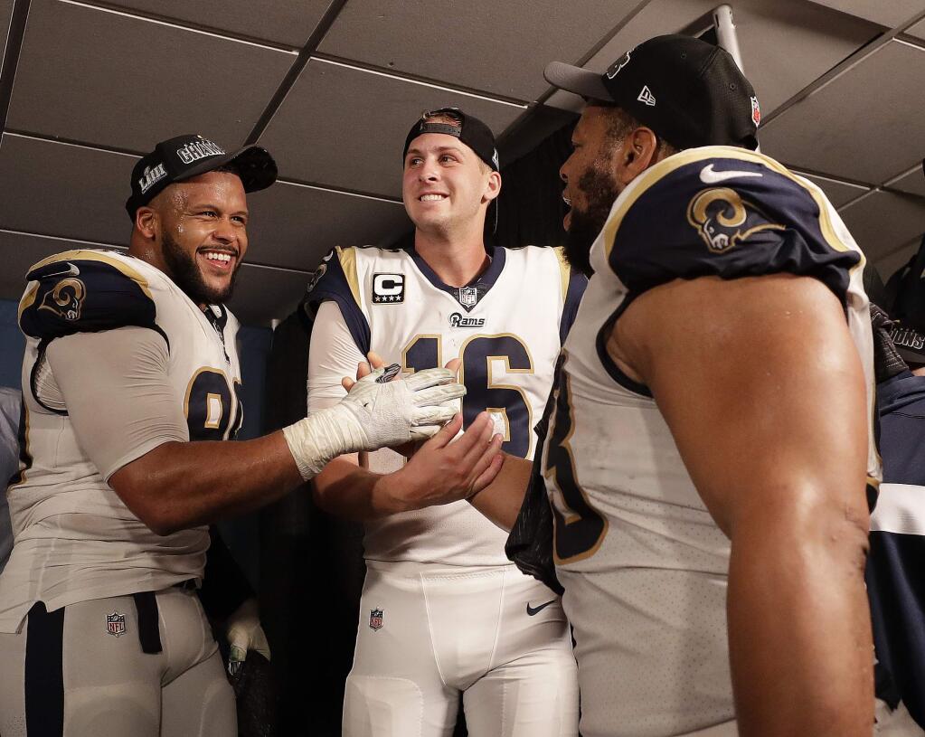 Los Angeles Rams defensive end Aaron Donald (99) Los Angeles Rams nose tackle Ndamukong Suh (93) and Los Angeles Rams quarterback Jared Goff (16) after overtime of the NFL football NFC championship game against the New Orleans Saints, Sunday, Jan. 20, 2019, in New Orleans. The Rams won 26-23.(AP Photo/David J. Phillip)