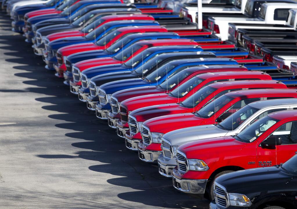 FILE - In this Jan. 5, 2015, file photo, Dodge Ram pickup trucks are on display on the lot at Landmark Dodge Chrysler Jeep RAM in Morrow, Ga. In a lawsuit filed Tuesday, May 23, 2017, the U.S. government is suing Fiat Chrysler, alleging that some diesel pickup trucks and Jeeps cheat on emissions tests. The Justice Department lawsuit alleges that nearly 104,000 Ram pickups and Jeep Grand Cherokees from the 2014 to 2016 model years have software that allows them to emit lower amounts of pollutants during lab tests by the Environmental Protection Agency than during normal driving conditions. (AP Photo/John Bazemore, File)