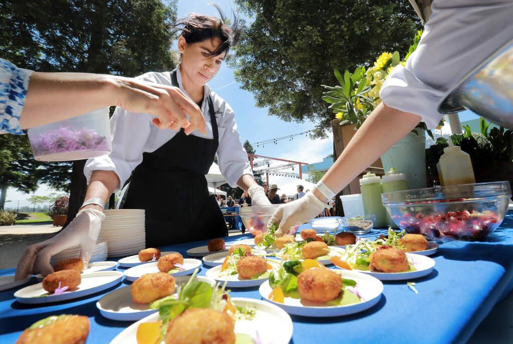 Regina Aronson with Ramekins Culinary helps create a duck confit croquette appetizer at the North Coast Food and Wine Festival at Sonoma Mountain Village in Rohnert Park. (JOHN BURGESS/PD)