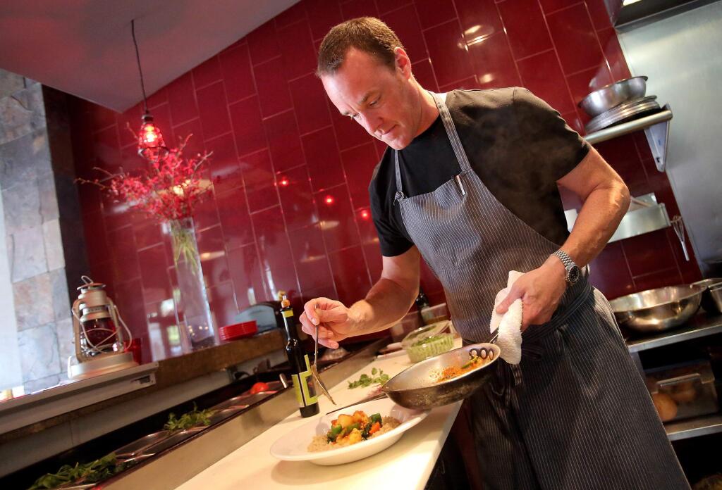Owner and executive chef Darren McRonald plates the vegetable korma served at The Pullman Kitchen in Santa Rosa in 2014. (CRISTA JEREMIASON/ PD FILE)
