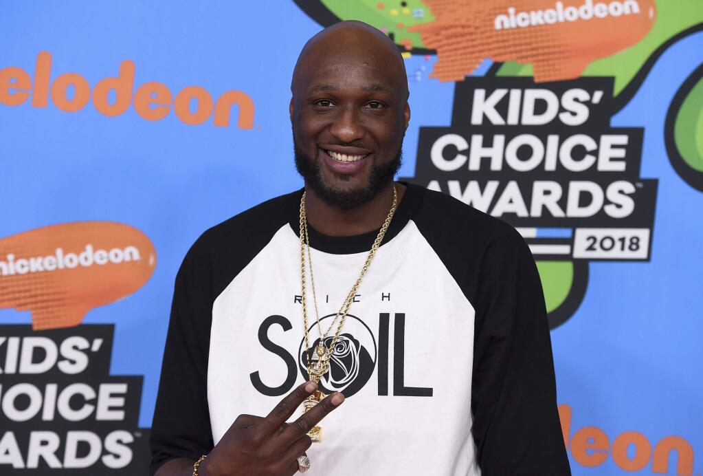 FILE - In this March 24, 2018 file photo, Lamar Odom arrives at the Kids' Choice Awards at The Forum in Inglewood, Calif. Odom regrets cheating on ex Khloé Kardashian and lying to her about his addiction to cocaine during their four-year marriage. The 39-year-old tells People magazine he wishes he “could have been more of a man” and it still bothers him three years after they divorced. (Photo by Jordan Strauss/Invision/AP, File)