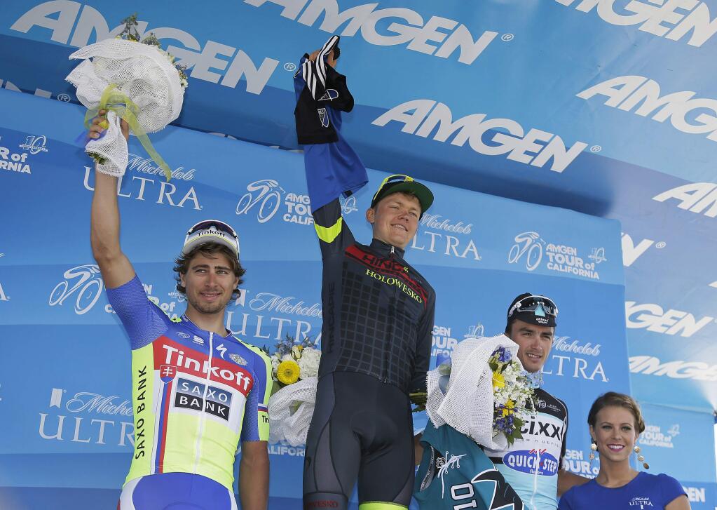 From left, Peter Sagan, of Slovakia; Toms Skujins, of Latvia; and Julian Alaphilippe, of France, stand on the podium after the third stage of the Tour of California cycling race Tuesday, May 12, 2015, in San Jose, Calif. Skujins, of the Hincapie Racing Team, won the stage and the yellow jersey, Sagan took second and Alaphilippe third. (AP Photo/Eric Risberg)