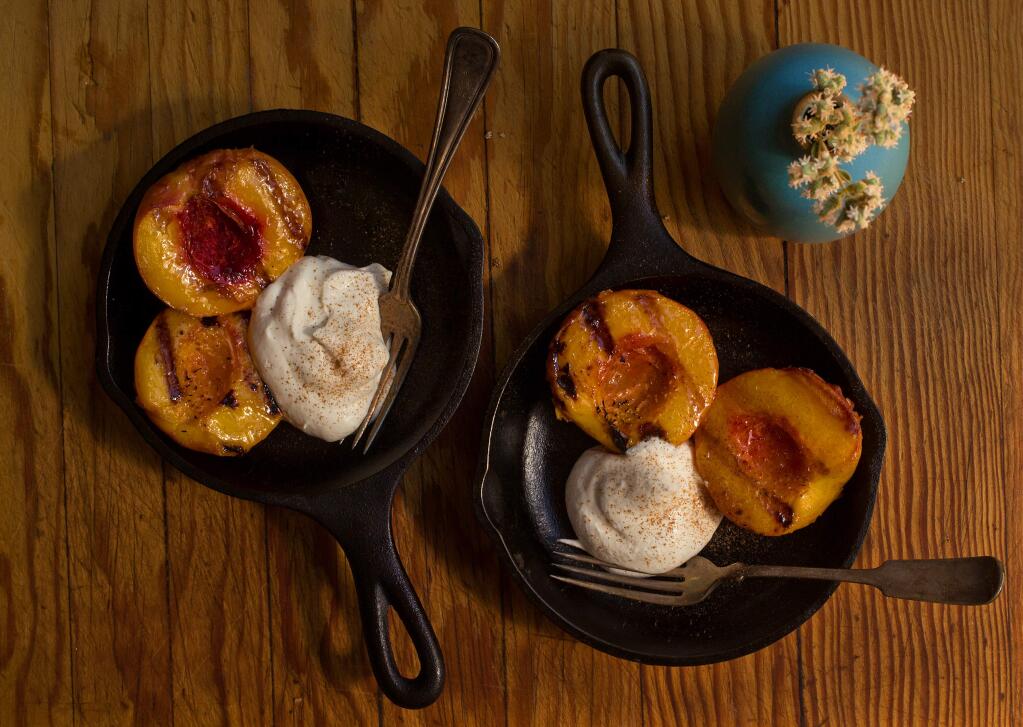 Grilled peaches with whipping cream. (photo by John Burgess/The Press Democrat)
