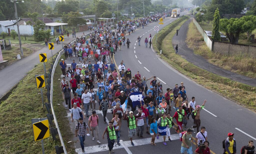 In this Oct. 21, 2018 photo, Central American migrants walking to the U.S. start their day departing Ciudad Hidalgo, Mexico. (AP Photo/Moises Castillo)