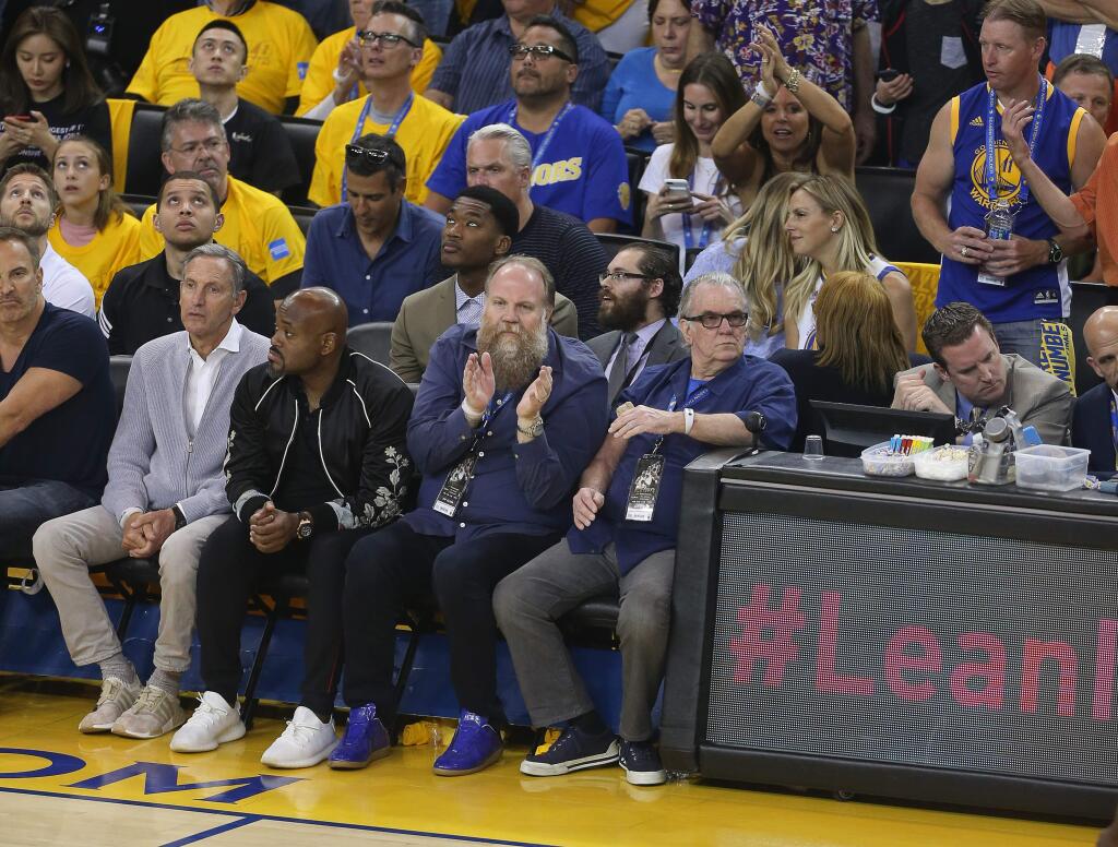Matt Swanson, center with beard, a season ticket holder at Oracle since the strike-shortened season in 2011, watches the Warriors play the Cleveland Cavaliers from his courtside seat during Game 2 of the NBA?Finals on Sunday in Oakland. (Christopher Chung / The Press Democrat)