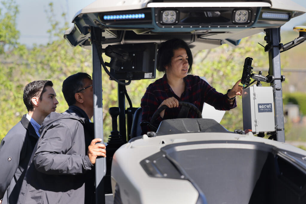 Mia Molinar, a Scout customer success manager, practices using the software on hardware mounted to a tractor during a demonstration day for clients in Napa, Tuesday, April 2, 2024. (Beth Schlanker / The Press Democrat)
