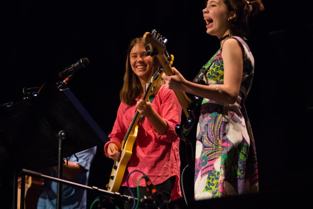 Student guitarists Harper Barankin, left, and Chloe Hoig perform with the Beatles Guitar Project. (Jason Vis)