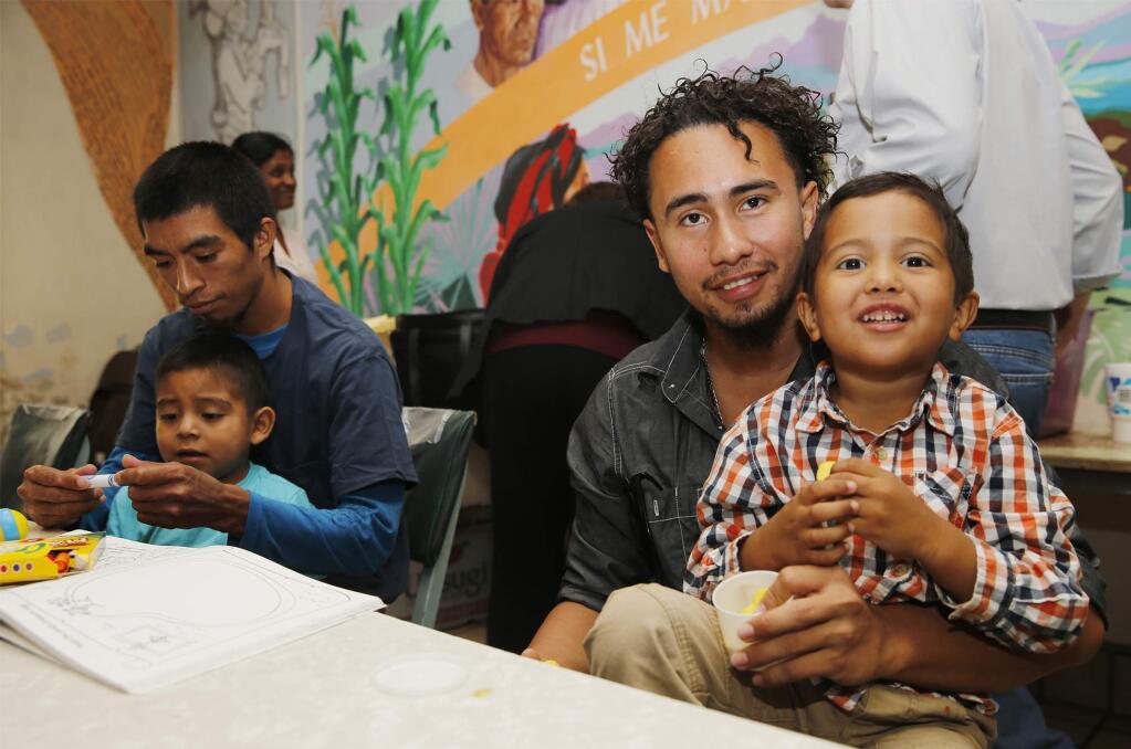 Roger Ardino, 24, and his son Roger Ardino Jr., 4, pose for a photo as they and Pablo Ortiz, 28, left, and his son Andres were speaking to members of the media during a news conference at the Annunciation House in El Paso, Texas, Wednesday, July 11, 2018. Ardino and Pablo Ortiz and his son Andres spoke to the media about their experiences while being detained and separated for several months from their sons. Tuesday night three fathers were reunited with their children but only two spoke this morning after the third, a father and daughter, had already left El Paso early Wednesday morning. (Ruben R. Ramirez/The El Paso Times via AP)