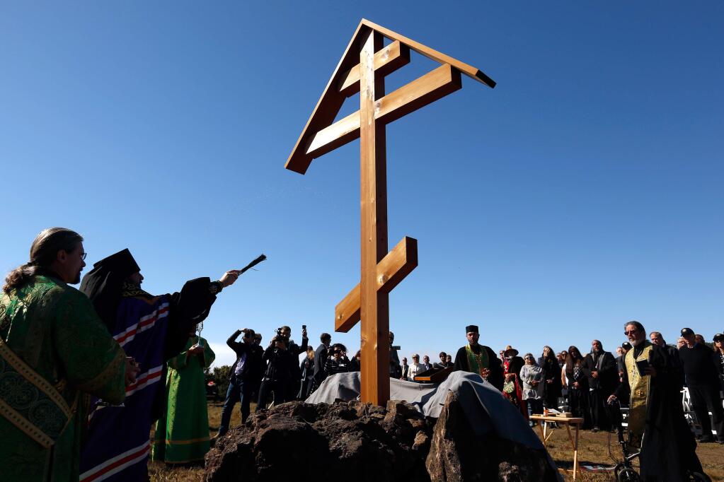 Russian Orthodox Church Bishop Feodosiy of Seattle, second from left, blesses the New Adoration Cross with holy water, during a dedication of the historic cemetery at Fort Ross State Historic Park, near Jenner, California, on Saturday, October 13, 2018. (Alvin Jornada / The Press Democrat)