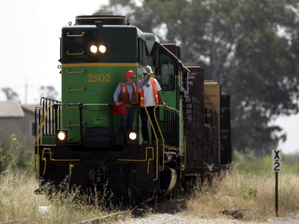 FILE PHOTO Employees with Balfour Beatty Rail, Inc. make their way north on the hitsoric Northwestern Pacific Rail line in Petaluma near Corona Road. The company was dropping railroad ties in preparation for repairs to the track to get it back up and running. (Crista Jeremiason / PD)