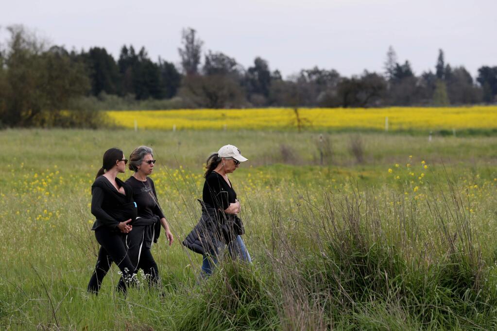 (From left)Laura Hutter, Anita Levine-Goldberg and Jenny DiLuvio, walk along the Laguna de Santa Rosa Trail in Santa Rosa, California on Tuesday, March 19, 2019 .(BETH SCHLANKER/The Press Democrat)