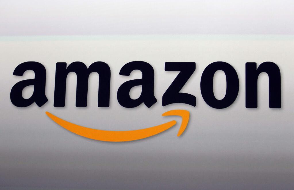 FILE - This Sept. 6, 2012, file photo, shows the Amazon logo in Santa Monica, Calif. Online leader Amazon Inc. has refused comment on reports that it plans to split its new headquarters between two locations. The Wall Street Journal and New York Times reported late Monday, Nov. 5, 2018, that the company would locate the new facilities in Queens in New York City and in the Crystal City area of Arlington, Virginia. (AP Photo/Reed Saxon, File)