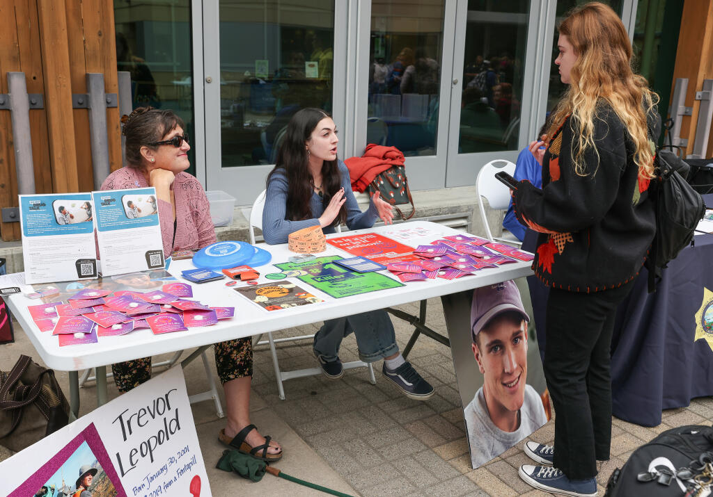 Michelle Leopold, left, and Emma Beckerle, founder of End Overdose at SSU, talk to Margaret Pavey about the program on the Sonoma State University campus in Rohnert Park, Wednesday, Oct. 25, 2023. Leopold’s son died of fentanyl poisoning in 2019. (Christopher Chung / The Press Democrat)