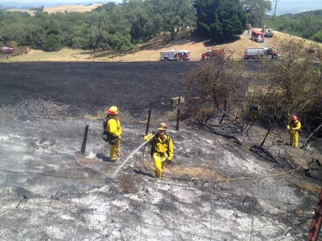 Scott Manchester/Argus-Courier StaffFirefighters put out a blaze on Sonoma Mountain Tuesday afternoon.