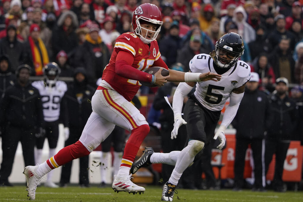 Chiefs quarterback Patrick Mahomes runs out of the pocket as Jacksonville Jaguars safety Andre Cisco defends during the first half of Saturday’s divisional round playoff game in Kansas City, Missouri. (Ed Zurga / ASSOCIATED PRESS)