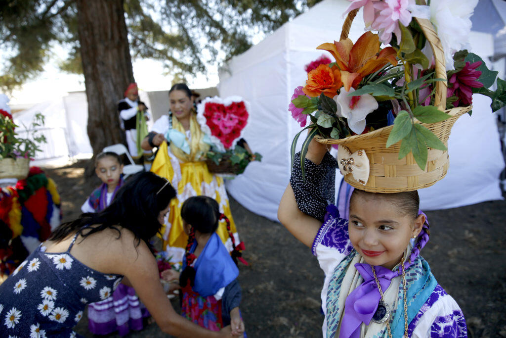 Angeline Camacho, 7, prepares to perform the Chinas dance during the Guelaguetza Tierra del Sol at the Luther Burbank Center for the Arts in Santa Rosa, Sunday, July 15, 2018. (Beth Schlanker / The Press Democrat file)