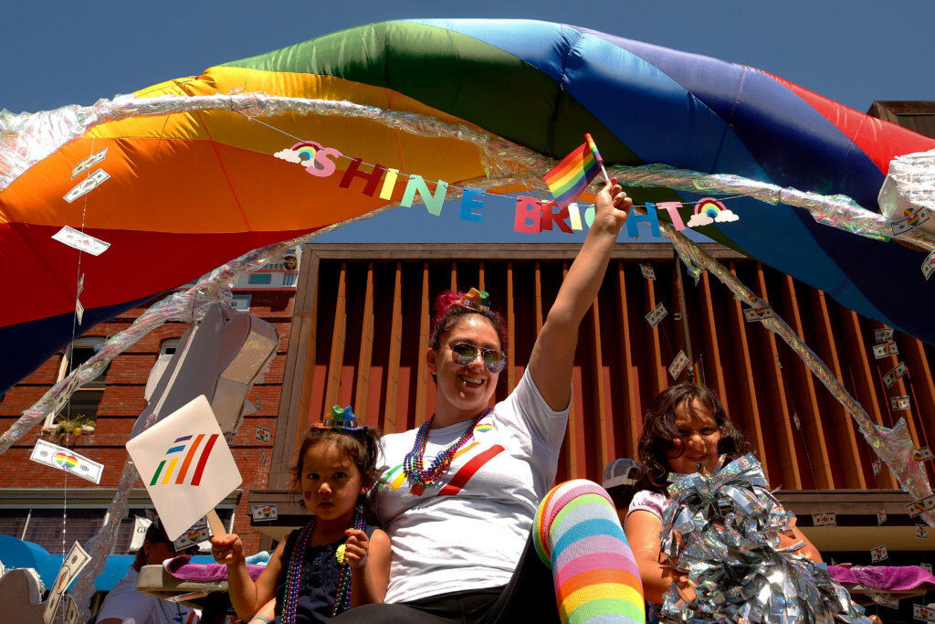 Devin Alvarez and her daughters Maleah, 2, and Nyeli, 5, ride down 4th Street on the Bank of America float during the Sonoma County Pride Parade in Santa Rosa, California, on Saturday, June 1, 2019. (Alvin Jornada / The Press Democrat)