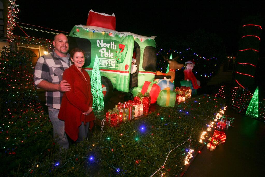 1725 Clairmont Ct., Andrea and Mark Tidwell and their award winning entry 'Santa's Workshop' in the 2014 Home Decorating Contest. (SCOTT MANCHESTER/ARGUS-COURIER STAFF)