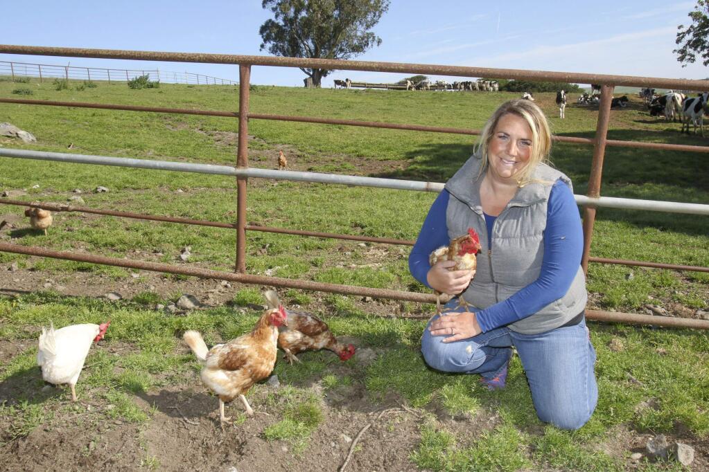 Jessica McIsaac with a few of her chickens that lay eggs for her at her McIsaac and Sons ranch in Two Rock on Tuesday, April 19, 2016. (SCOTT MANCHESTER/ARGUS-COURIER STAFF)