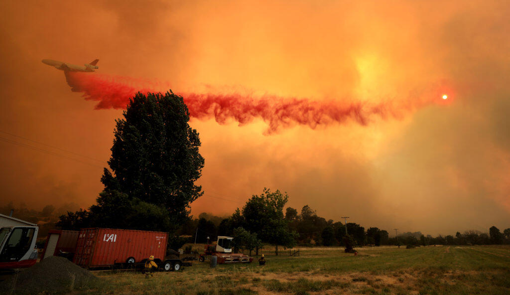 An air tanker is used to paint a retardant line as fire rolls off Cow Mountain, Tuesday afternoon July 31, 2018.  The fire blew in to Scotts Valley and impacted several homes off Hendricks Rd. Near Lakeport. (Kent Porter / The Press Democrat) 2018
