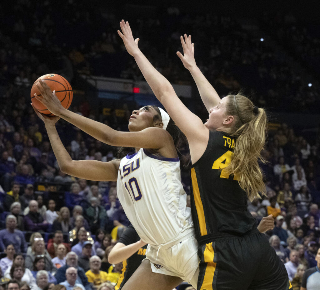FILE - LSU forward Angel Reese (10) drives past Missouri forward Hayley Frank (43) during an NCAA college basketball game Thursday, Jan. 4, 2024, in Baton Rouge, La. As March Madness is set to tip off, three of the most recognizable names in college basketball are in the women’s tournament: Caitlin Clark, Angel Reese and Paige Bueckers.(Hilary Scheinuk/The Advocate via AP, File)