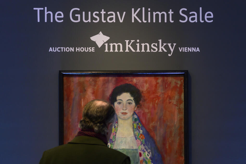 A man looks at the painting 'Portrait of Fräulein Lieser' by Austrian painter Gustav Klimt prior to an auction, in Vienna, Wednesday, April 24, 2024. A portrait of a young woman by Gustav Klimt that was long believed to be lost has been sold at an auction in Vienna for 30 million euros ($32 million). The Austrian modernist artist started work on the “Portrait of Fräulein Lieser” in 1917, the year before he died, and it is one of his last works. (AP Photo/Christian Bruna)