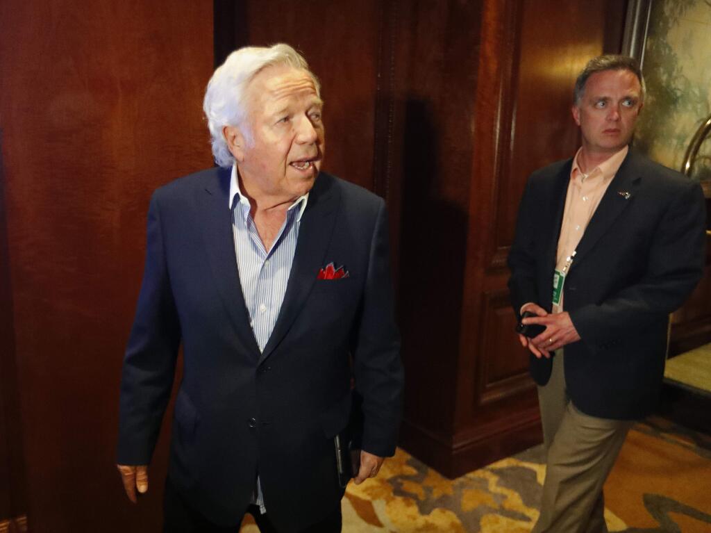 New England Patriots owner Robert Kraft, left, speaks to reporters as he enters the NFL owners spring meeting Tuesday, May 22, 2018, in Atlanta. (AP Photo/John Bazemore)