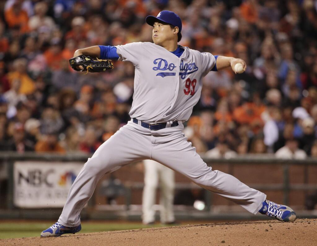 Los Angeles Dodgers starting pitcher Hyun-Jin Ryu throws to the San Francisco Giants during the first inning of a baseball game Friday, Sept. 12, 2014, in San Francisco. (AP Photo/Marcio Jose Sanchez)