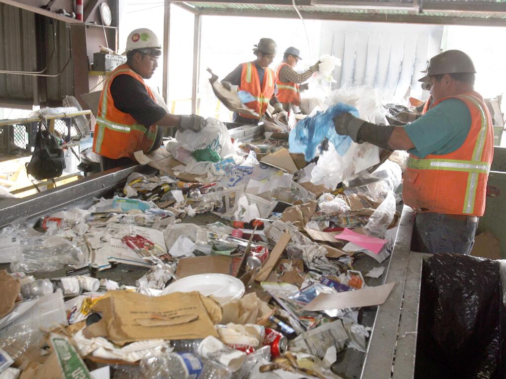 (FILE PHOTO) Workers sort plastic bags from recycling materials at North Bay Corp. in Santa Rosa. (Scott Manchester / The Press Democrat) 2008