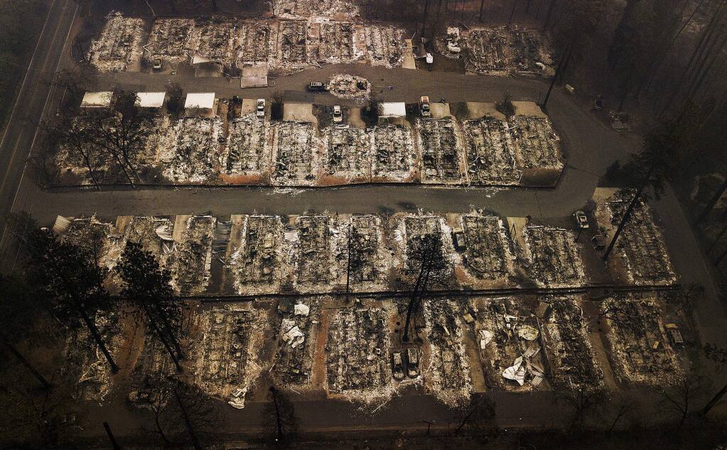 FILE - This Nov. 15, 2018, file photo, shows the remains of residences leveled by a wildfire in Paradise, Calif. (AP Photo/Noah Berger, File)