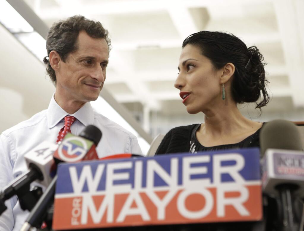 FILE - In this July 23, 2013 file photo, Huma Abedin, alongside her husband, then-New York mayoral candidate Anthony Weiner, speaks during a news conference in New York. Democratic presidential candidate Hillary Clinton aide Huma Abedin says she is separating from husband Anthony Weiner after another sexting revelation involving the former congressman from New York. (AP Photo/Kathy Willens, File)