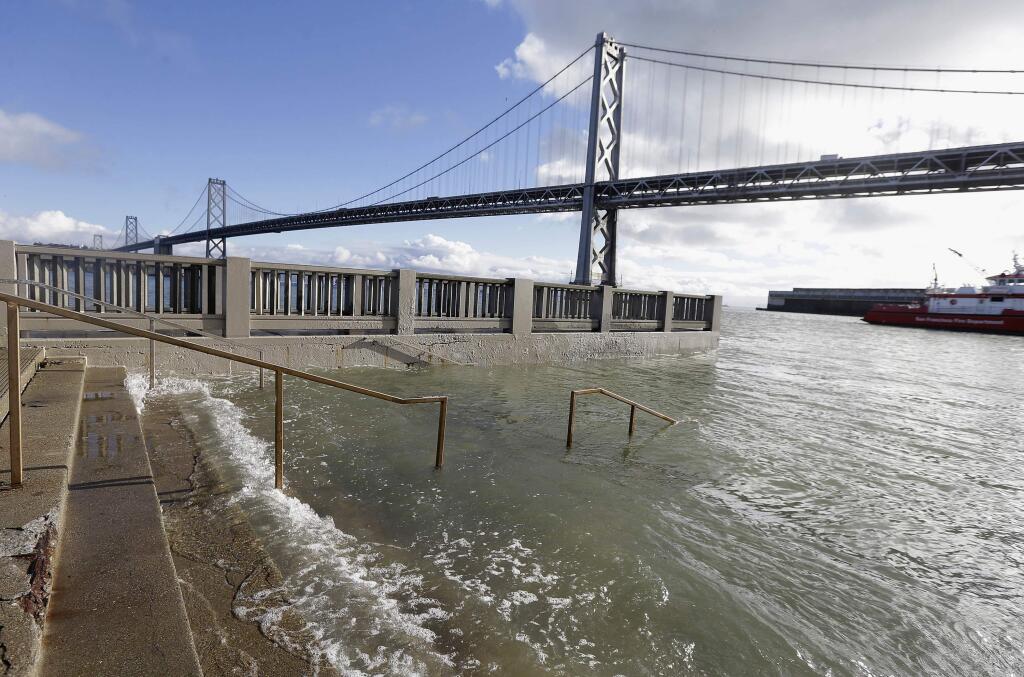 FILE - In this Jan. 11, 2017, file photo, water from a king tide floods a staircase along the Embarcadero in San Francisco. The state's Ocean Protection Council decided Wednesday, April 26 to update its sea-rise guidance for state and local governments. That's mainly because of findings that Antarctic ice sheets are melting increasingly fast. The new projections forecast at least a 1-foot (one-third meter) rise off California by the end of the century. That jumps to 10-feet (3 meters) if the Antarctic ice sheets melt far more rapidly. (AP Photo/Jeff Chiu, File)