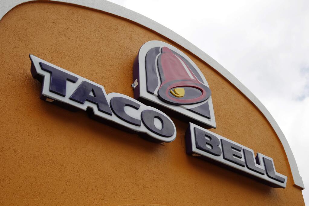 FILE - This Friday, May 23, 2014, file photo, shows the sign at a Taco Bell in Mount Lebanon, Pa. Taco Bell spokesman Rob Poetsch said Feb. 23, 2017, that theits Naked Chicken Chalupa, a sandwhich with a shell made out of fried chicken, will be pulled from menus as it was always intended to be a limited time offer. (AP Photo/Gene J. Puskar, File)