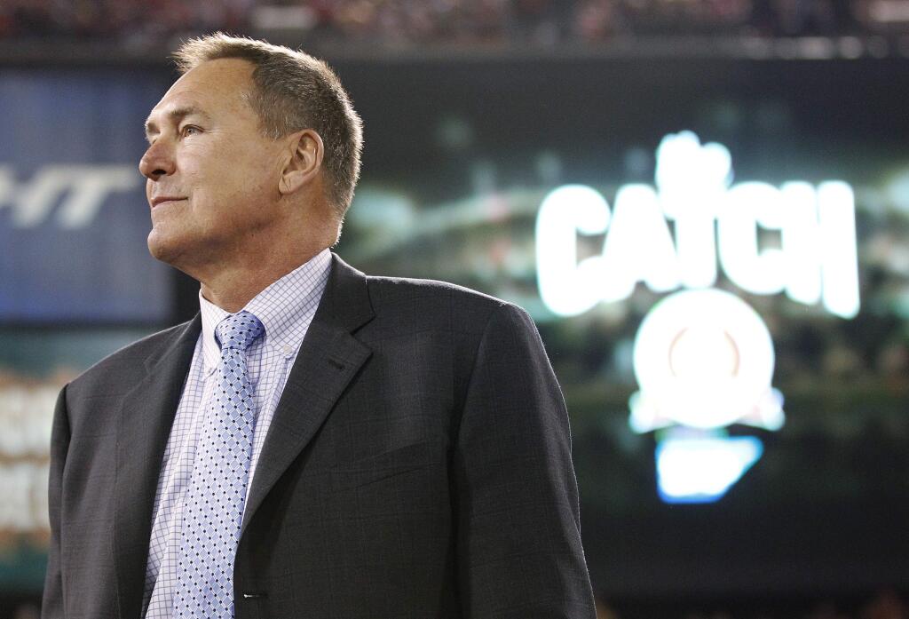 Dwight Clark, shown at a halftime ceremony in 2013, announced this week that he has Lou Gehrig's disease and suspects that playing football contributed to the illness. (TONY AVELAR / Associated Press)