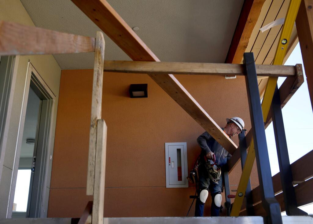Jason Wilson of Union Framing builds as balcony railing as work continues on the new Fetters Apartment complex, part of the Sonoma Springs Hub,in Sonoma, on Wednesday, November 16, 2016. (BETH SCHLANKER/ The Press Democrat)