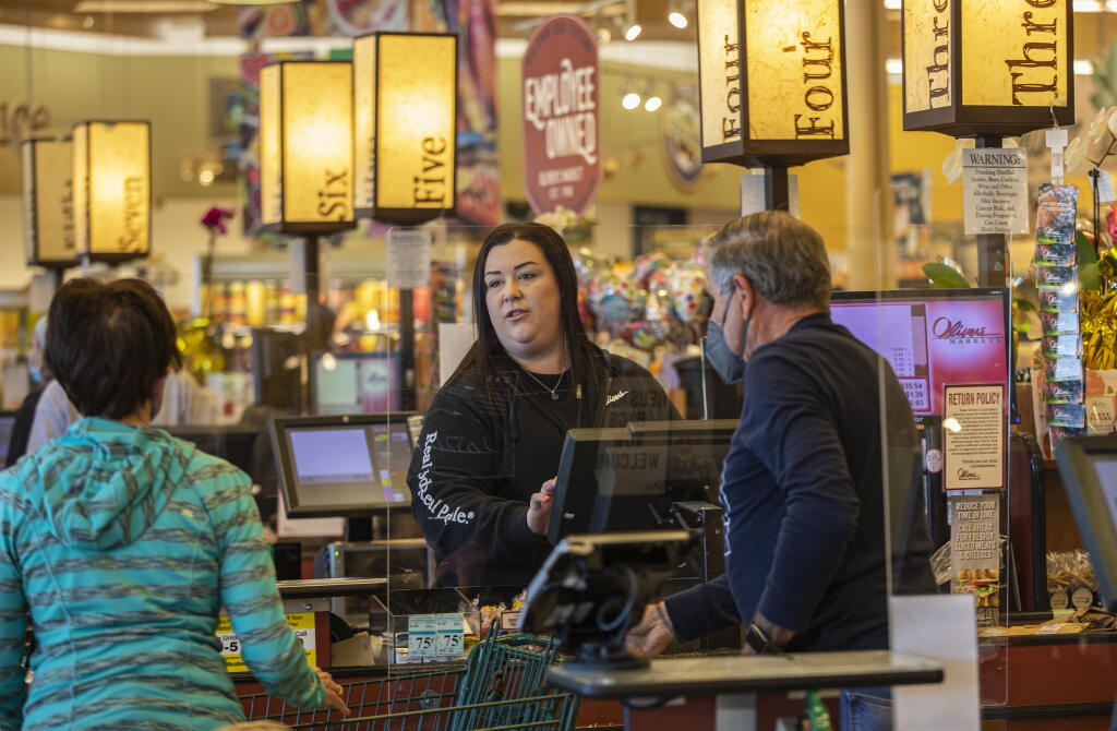 As the county eases mask restrictions, Oliver’s Store Lead Melissa Reynold’s greets customers checking out at the Stony Point Rd. Oliver’s in Santa Rosa on Friday March 11, 2022. (Chad Surmick / The Press Democrat)