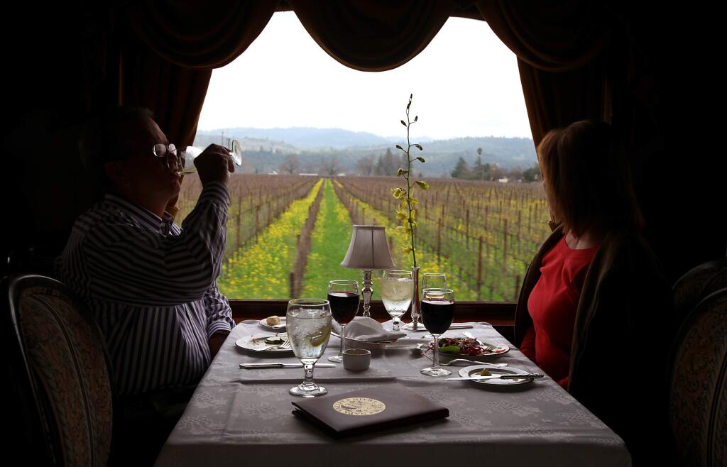Vince and Karen Taylor drink wine and take in the vineyard views as they dine aboard the Napa Valley Wine Train on Friday, January 29, 2010.