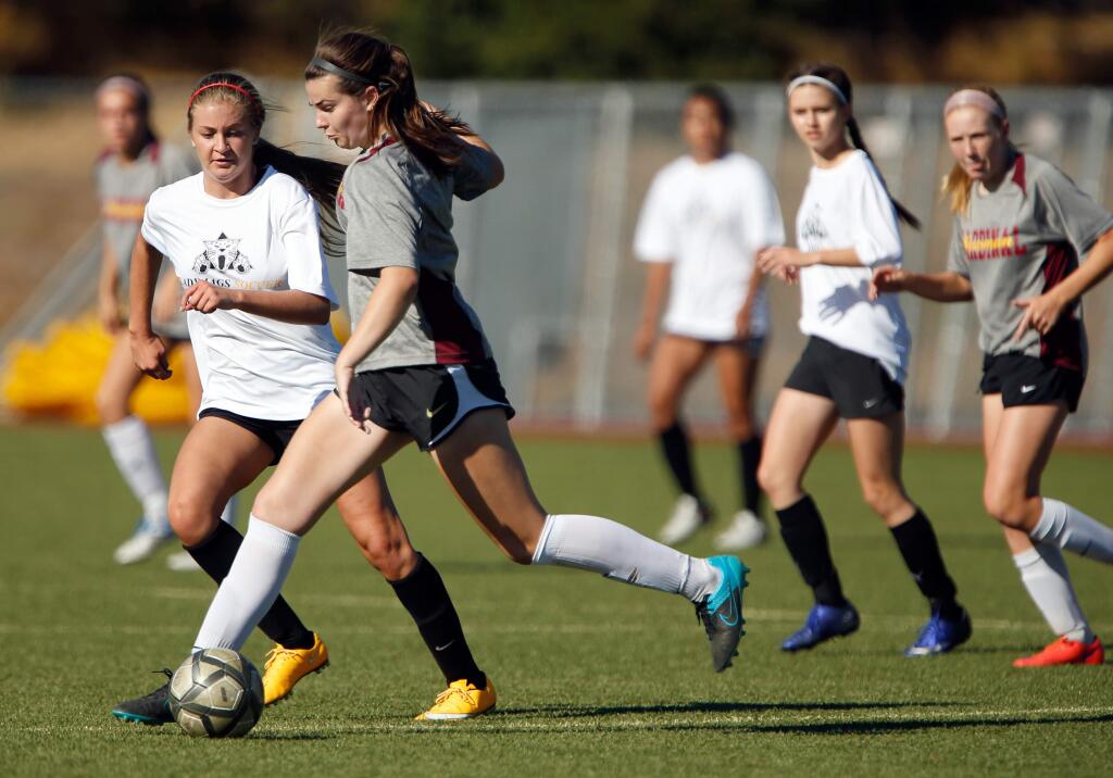 Cardinal Newman's Lauren Miller, second from left, controls the ball while defended by Windsor's Madi Baer, left, during a girls varsity soccer scrimmage match between Windsor and Cardinal Newman high schools, in Santa Rosa, California on Wednesday, August 31, 2016. (Alvin Jornada / The Press Democrat)