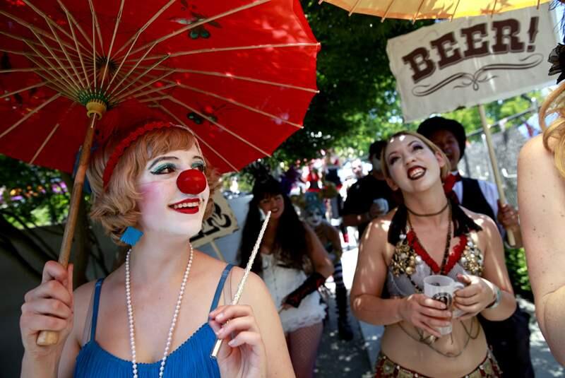 Katrina Kroetch, left, and Bramani Quinn, take part in a parade during the Lagunitas Beer Circus on Sunday, June 8, 2014 in Petaluma, California. (BETH SCHLANKER/ The Press Democrat)