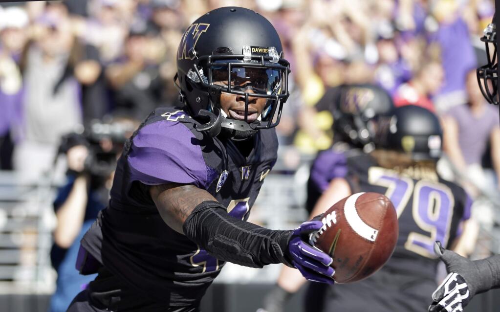 Washington's Jaydon Mickens celebrates after scoring on a 25-yard pass reception against Stanford in the first half of an NCAA football game Saturday, Sept. 27, 2014, in Seattle. (AP Photo/Elaine Thompson)