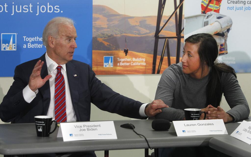 Vice President Joe Biden, left, speaks with Lauren Gonzales, a veteran and a student in a Pacific Gas & Electric Power Pathway class, during a workforce development program at a PG&E Service Center in Oakland, Calif., Friday, April 10, 2015. (AP Photo/San Francisco Chronicle, Paul Chinn, Pool)