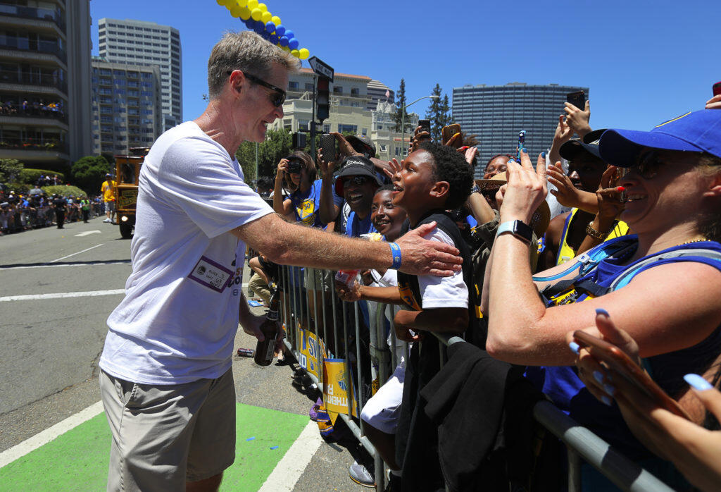 Warriors head coach Steve Kerr talks to a young fan, during the team’s victory parade in Oakland on Tuesday, June 12, 2018.   (Christopher Chung/ The Press Democrat)